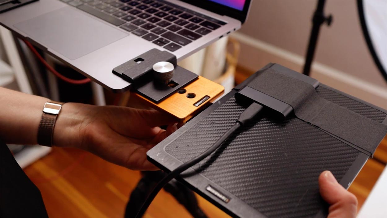 Photographer using portable hard drive backup